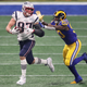 Rob Gronkowski #87 of the New England Patriots runs the ball against Samson Ebukam #50 of the Los Angeles Rams in the second half during Super Bowl LIII at Mercedes-Benz Stadium on February 3, 2019 in Atlanta, Georgia.
